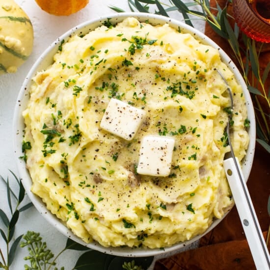 A bowl of mashed potatoes with feta cheese.