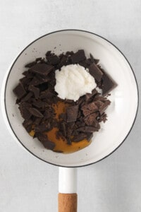 A bowl filled with chocolate chips and whipped cream.