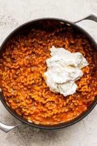 A pan filled with pasta and sour cream.