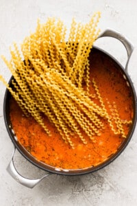 Spaghetti in tomato sauce in a pan.