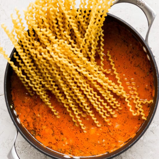Spaghetti in tomato sauce in a pan.