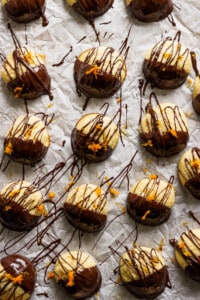 A bunch of chocolate covered donuts on a piece of paper.