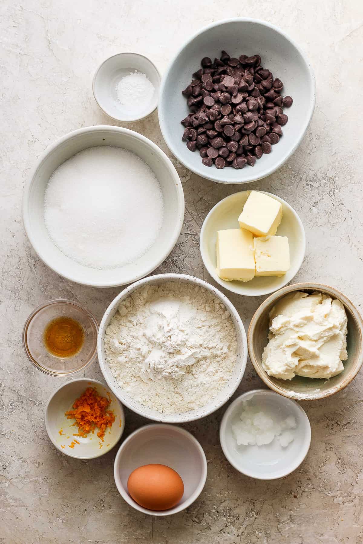 The ingredients for a chocolate cake are shown in bowls on a table.