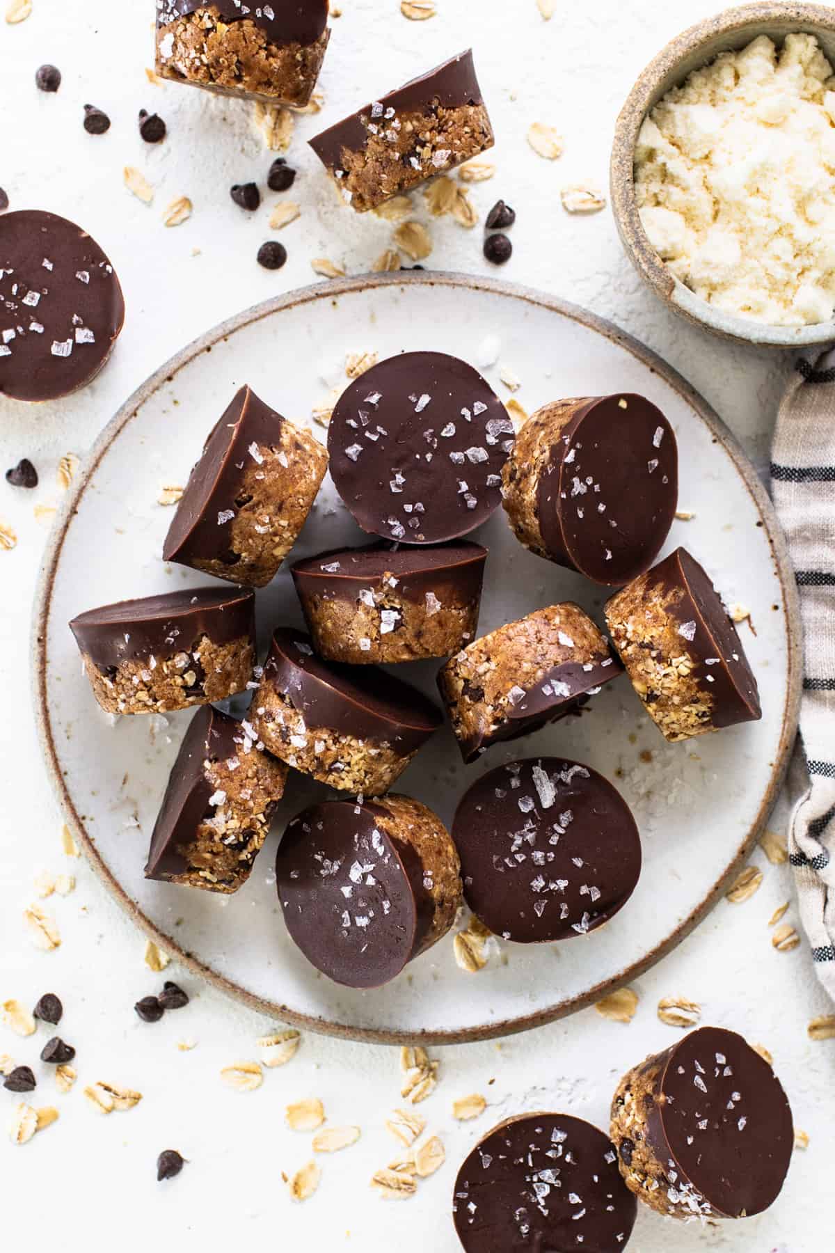 A plate topped with chocolate covered granola bars.