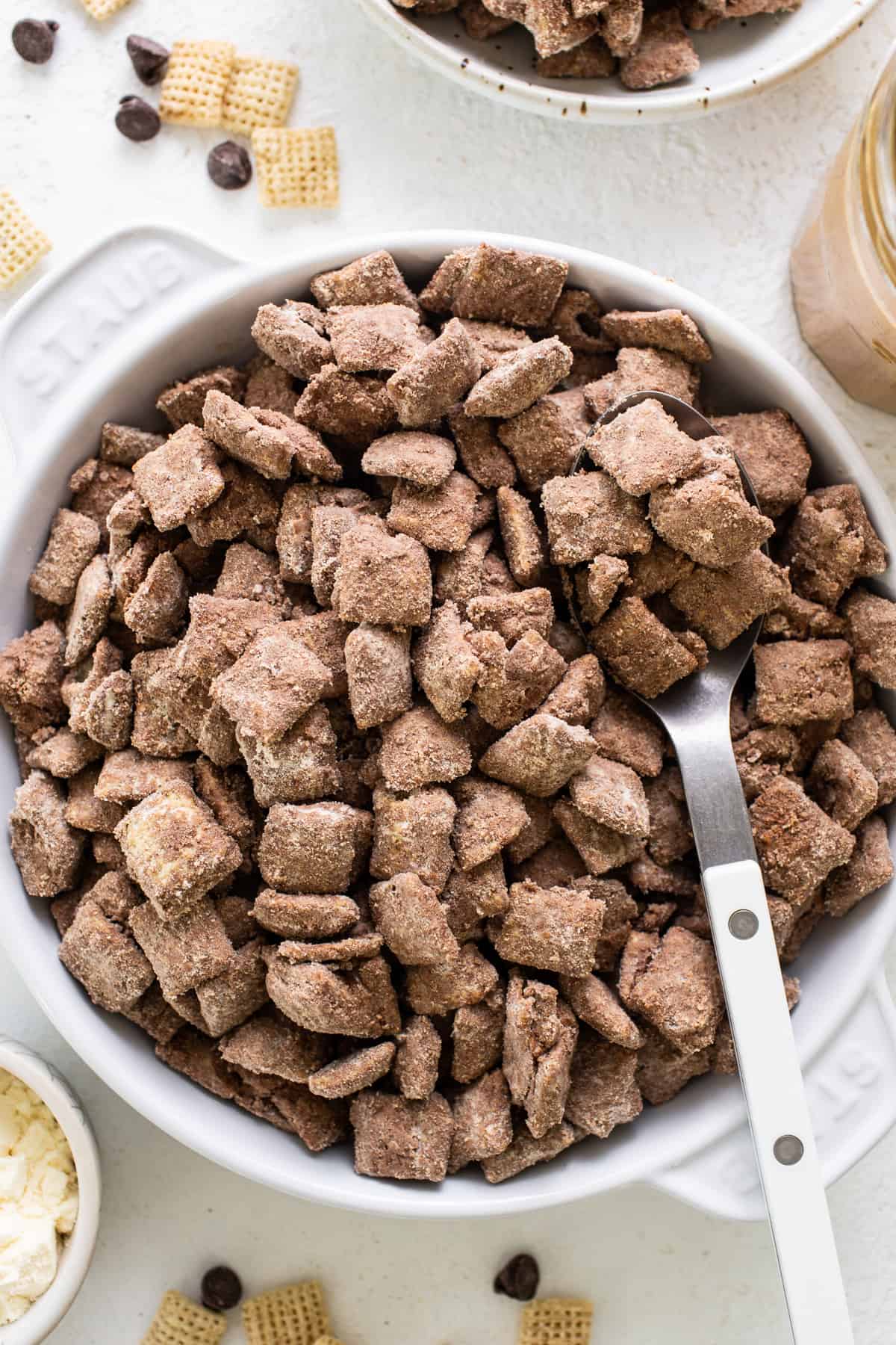 Chocolate peanut butter cheetos in a bowl with a spoon.