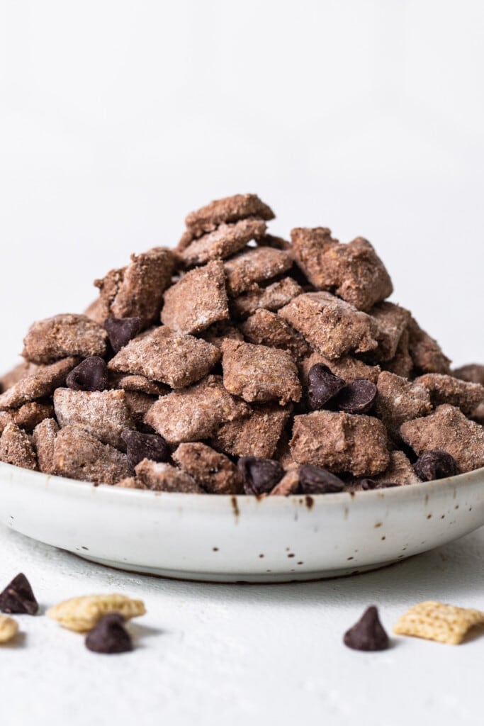 A bowl of chocolate chips on a white background.