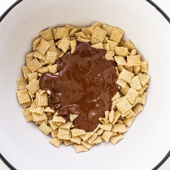 A bowl filled with chocolate and cheetos.