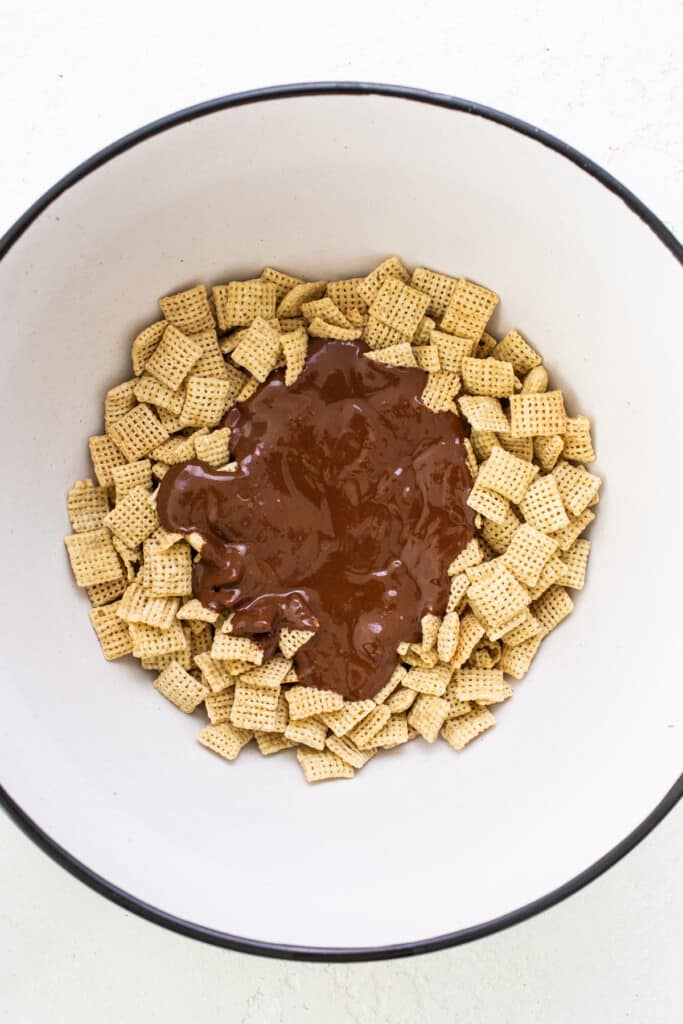 A bowl filled with chocolate and cheetos.