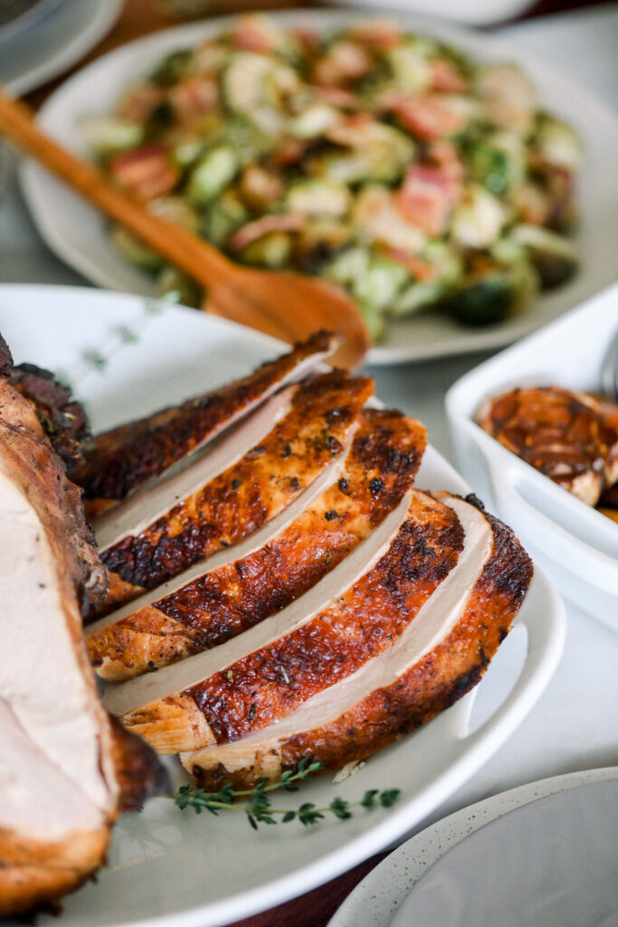 A plate with a Sous Vide turkey and vegetables on it.