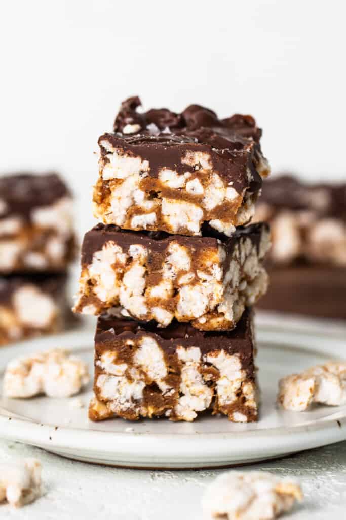 A stack of chocolate graham cracker bars on a plate.
