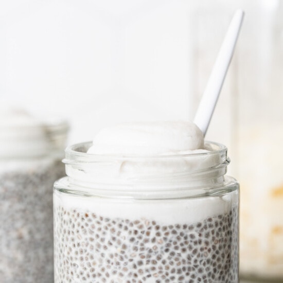 Chia pudding in a jar with a spoon.