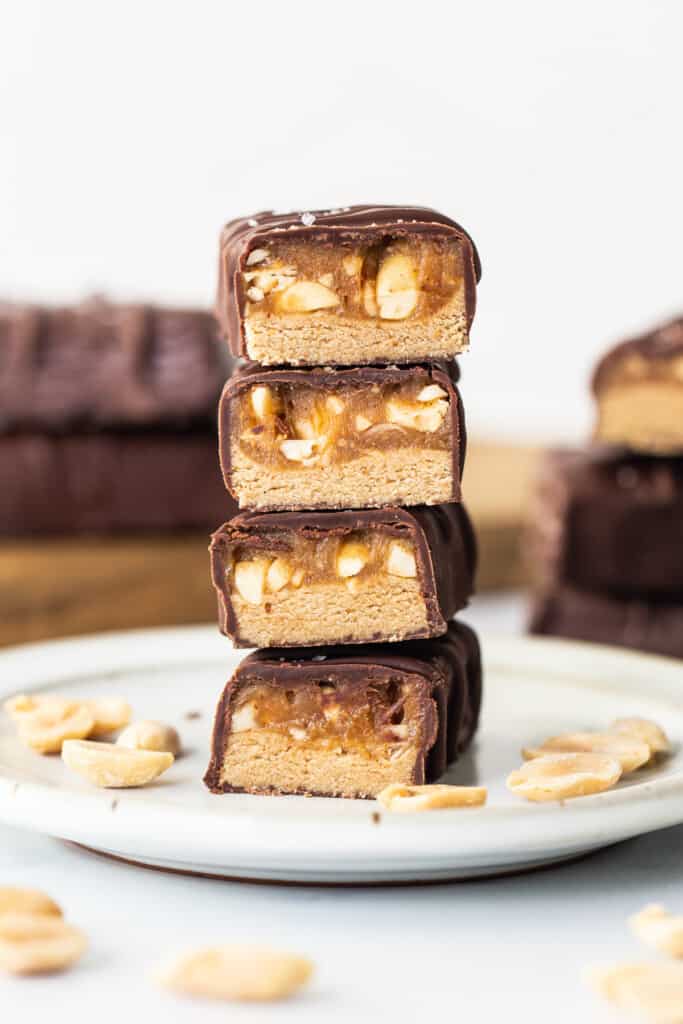 A stack of chocolate peanut butter bars on a plate.