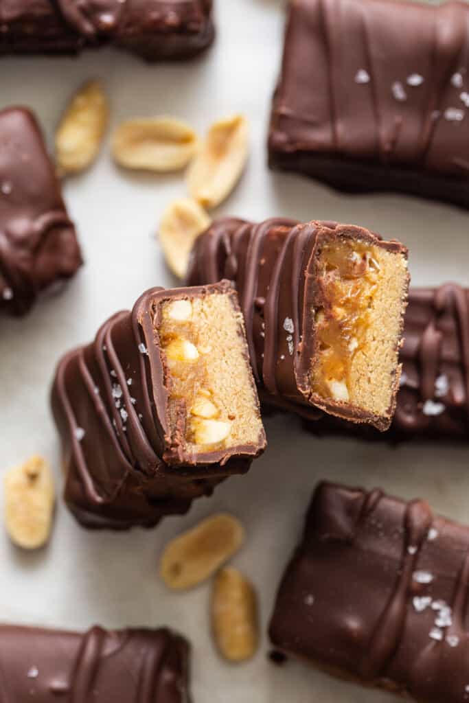 Chocolate peanut butter bars with peanuts on top.