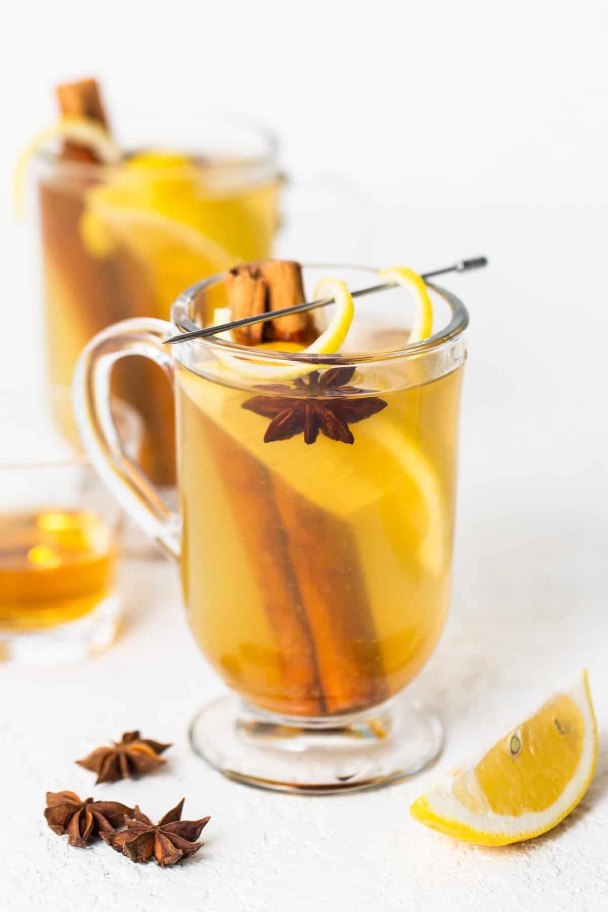 A cup of mulled cider with cinnamon and star anise.