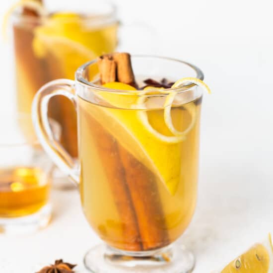 A cup of lemon tea with cinnamon and star anise.