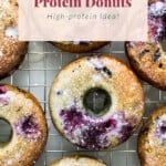 Blueberry protein donuts on a cooling rack.