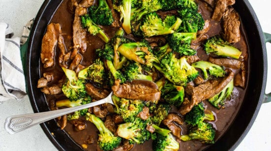 Beef and broccoli stir fry in a skillet.