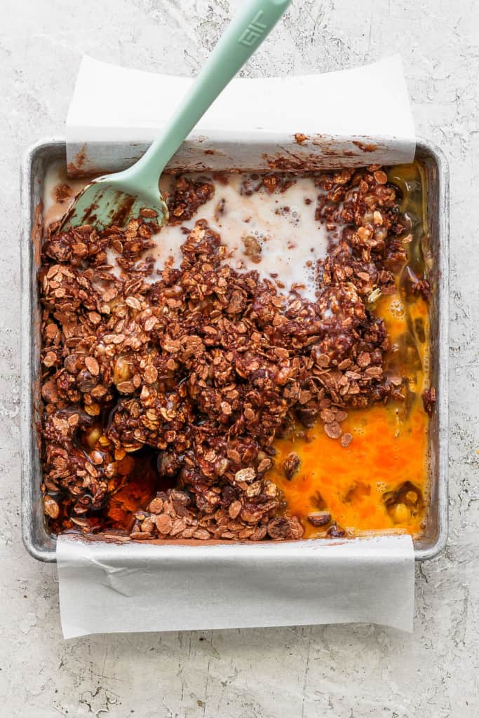 A baking pan with a scoop of granola in it.