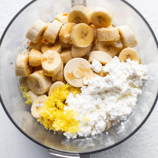 A bowl of food with bananas and cottage cheese.