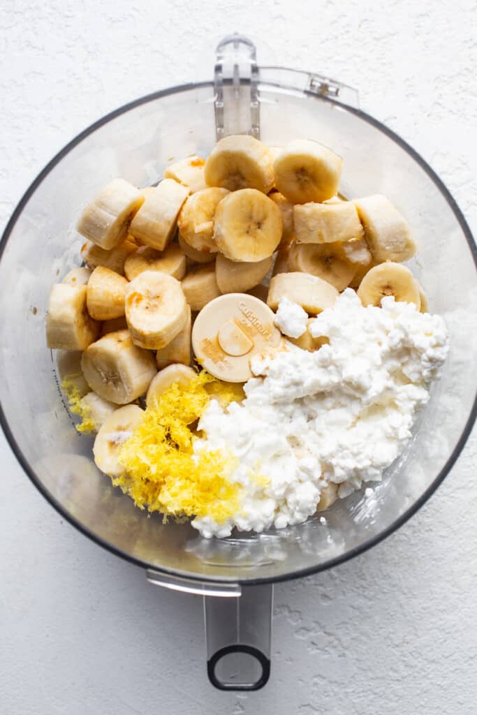 A bowl of food with bananas and cottage cheese.