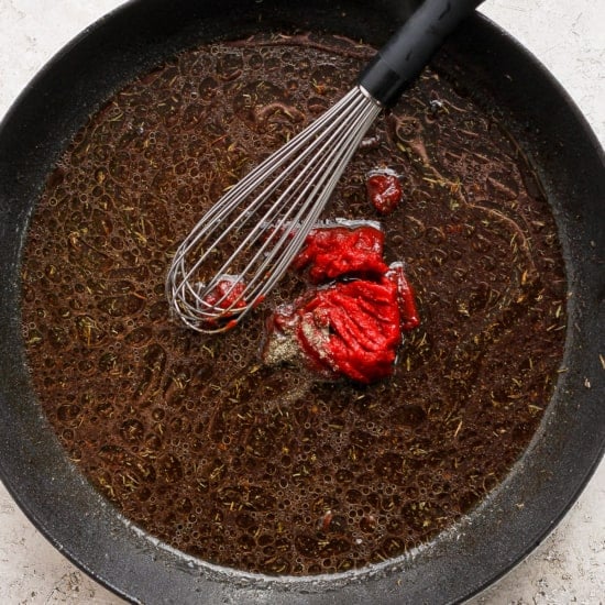 A frying pan with a red pepper in it.