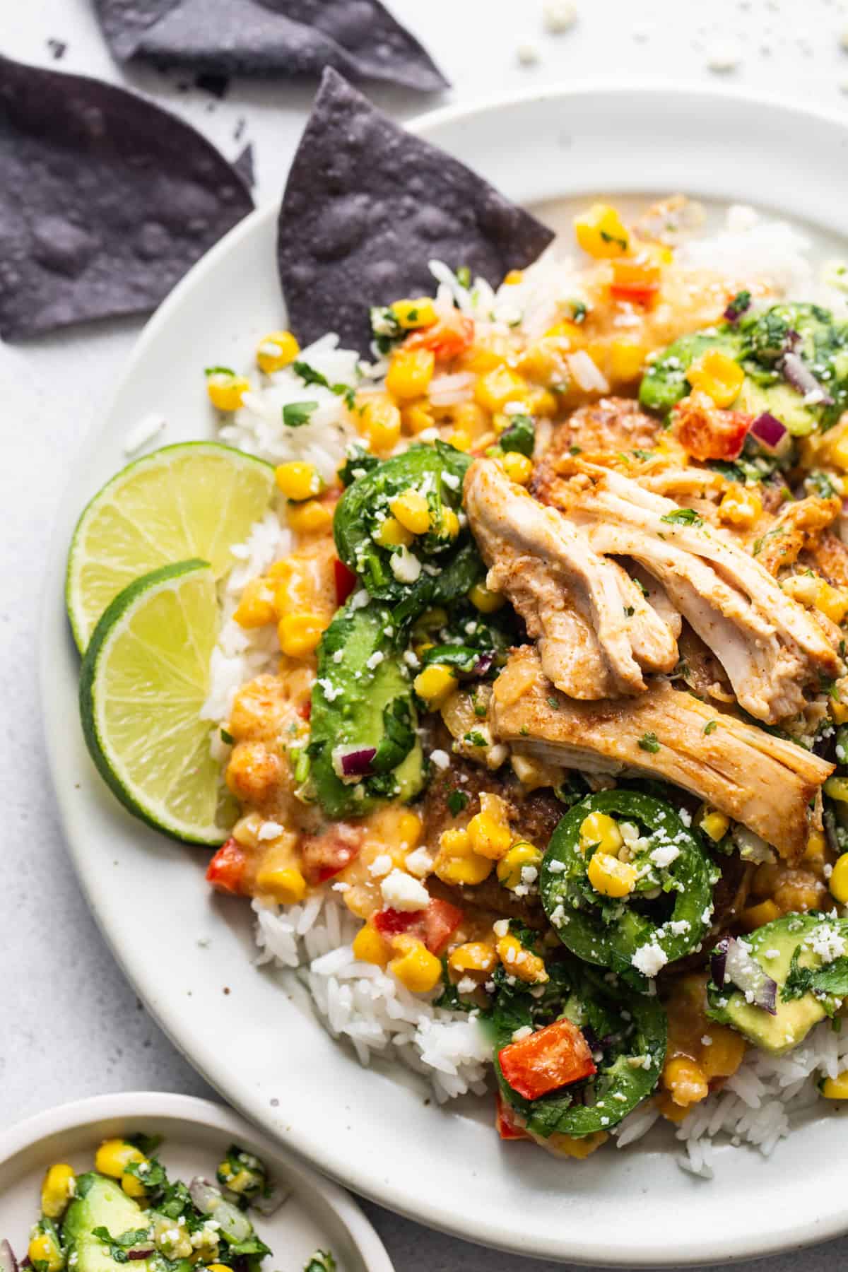 A white plate with chicken and vegetables on it.