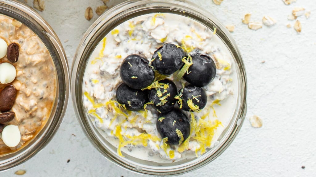 Three jars of oatmeal with black olives and almonds.