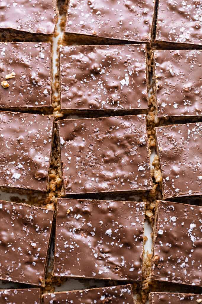 A close-up of chocolate squares on a white plate.