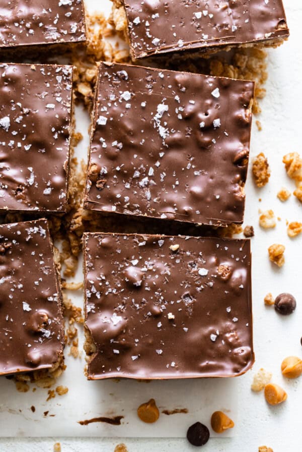 A sheet of chocolate covered granola bars on a cutting board.
