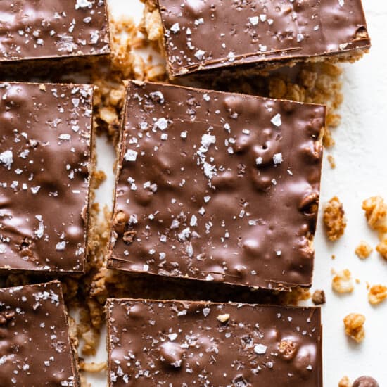 A plate of chocolate granola bars on a white surface.