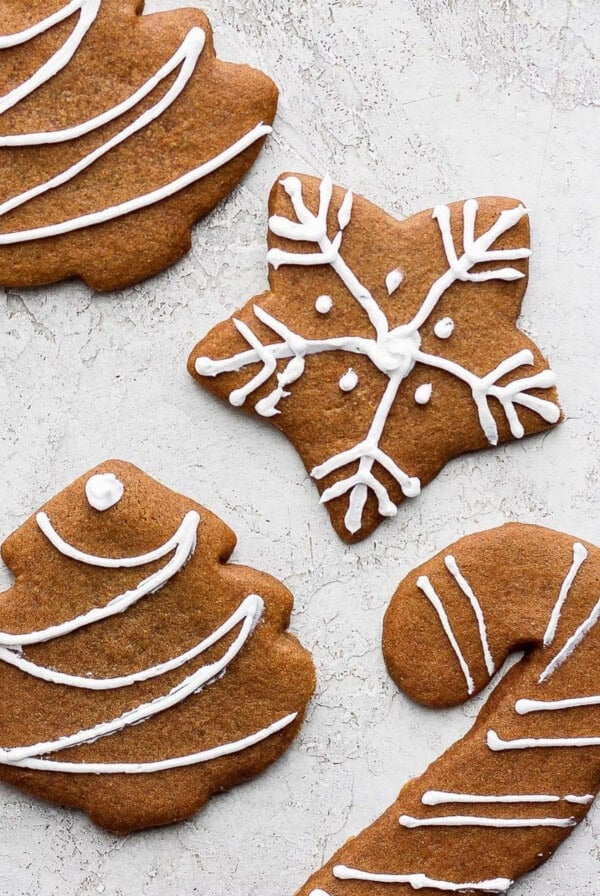 Gingerbread cookies decorated with icing and candy canes.