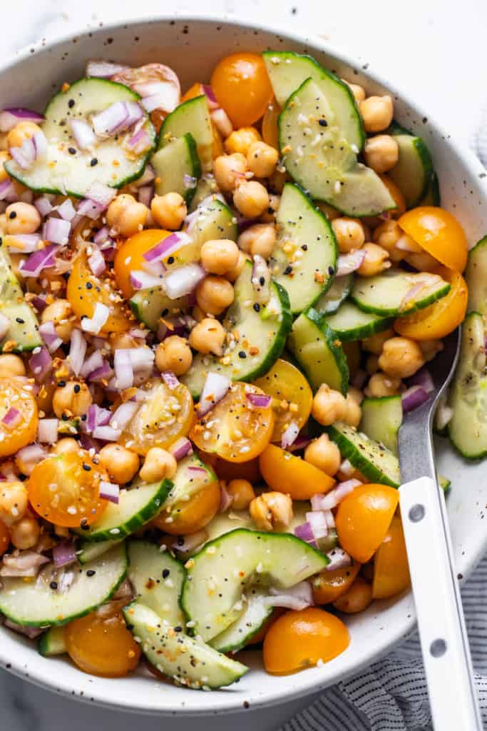 Salad with chickpeas and cucumber in a bowl.
