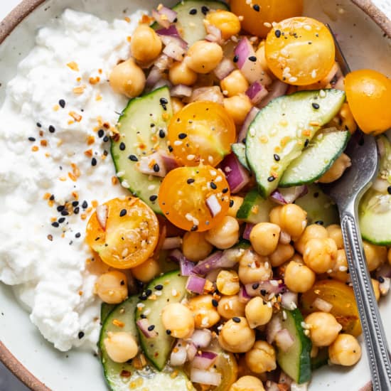 A bowl of chickpeas, cucumbers and yoghurt.