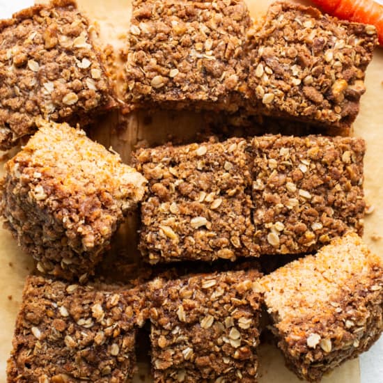 Carrot bars with oats and carrots on a cutting board.