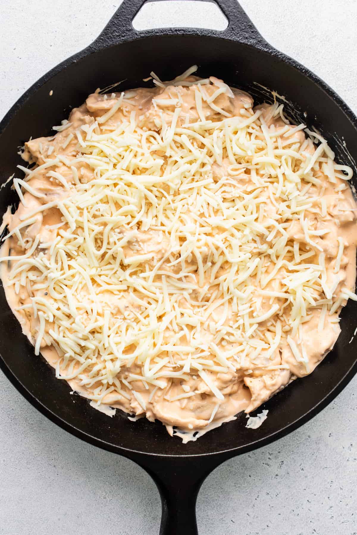 Cheesy nachos in a cast iron skillet.