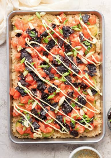 A tray with a pizza with toppings on it.