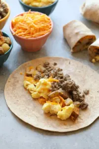 Make ahead breakfast burritos with sausage, eggs, and cheese.