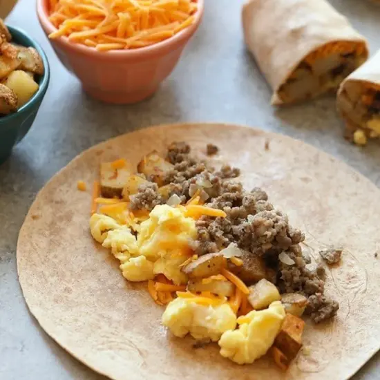 Make ahead breakfast burritos with sausage, eggs, and cheese.