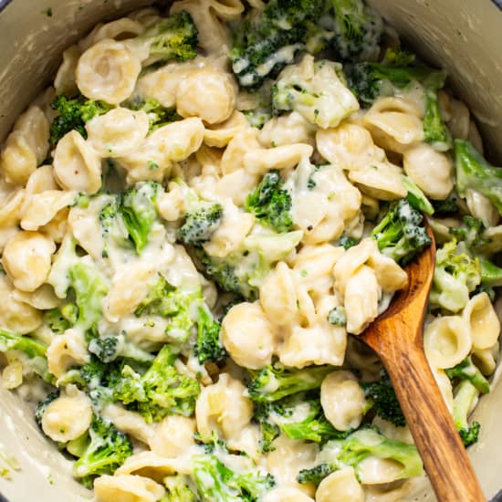 A pot of pasta with broccoli and cheese.