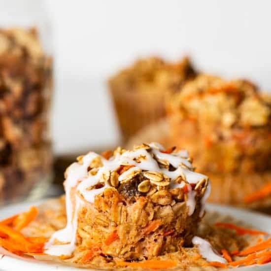 Carrot muffins on a plate with a jar of granola.