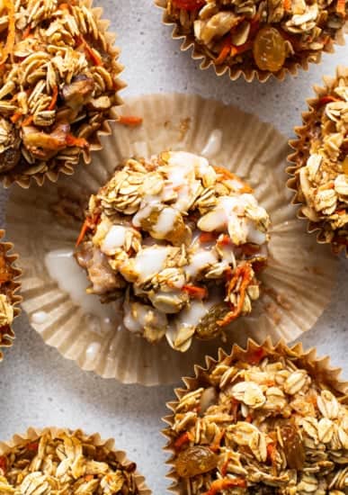 A group of muffins topped with granola.