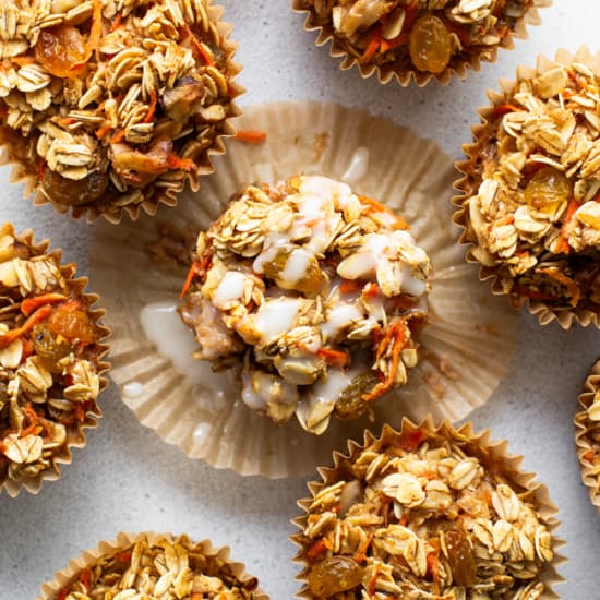 A group of granola muffins on a white surface.