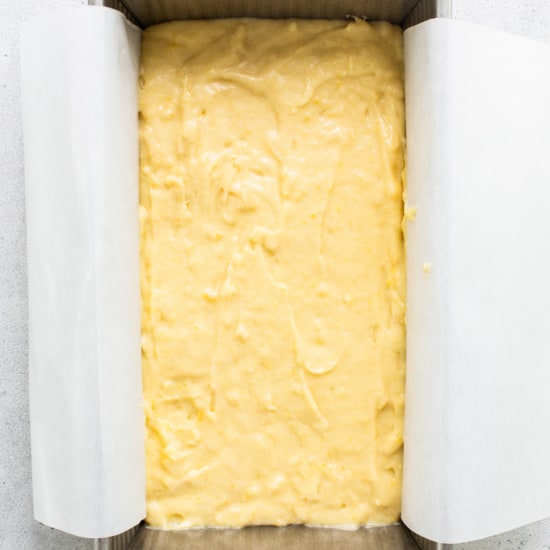 A square of yellow cake in a baking pan.