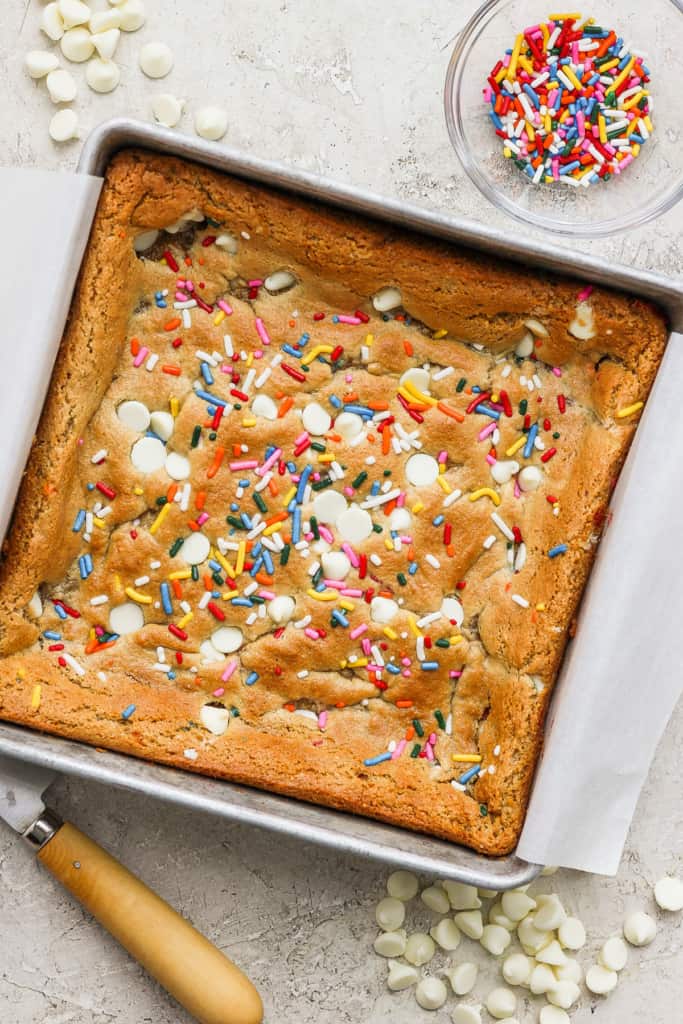 A cake with sprinkles in a pan.
