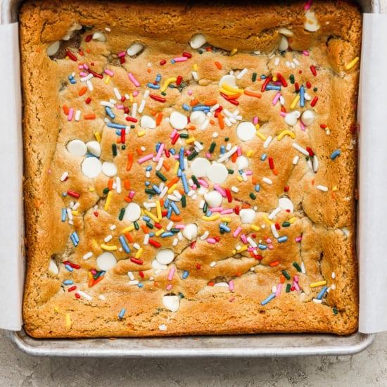 A cookie bar with sprinkles in a pan.