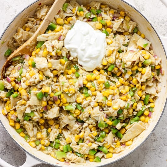 A skillet filled with corn and sour cream.