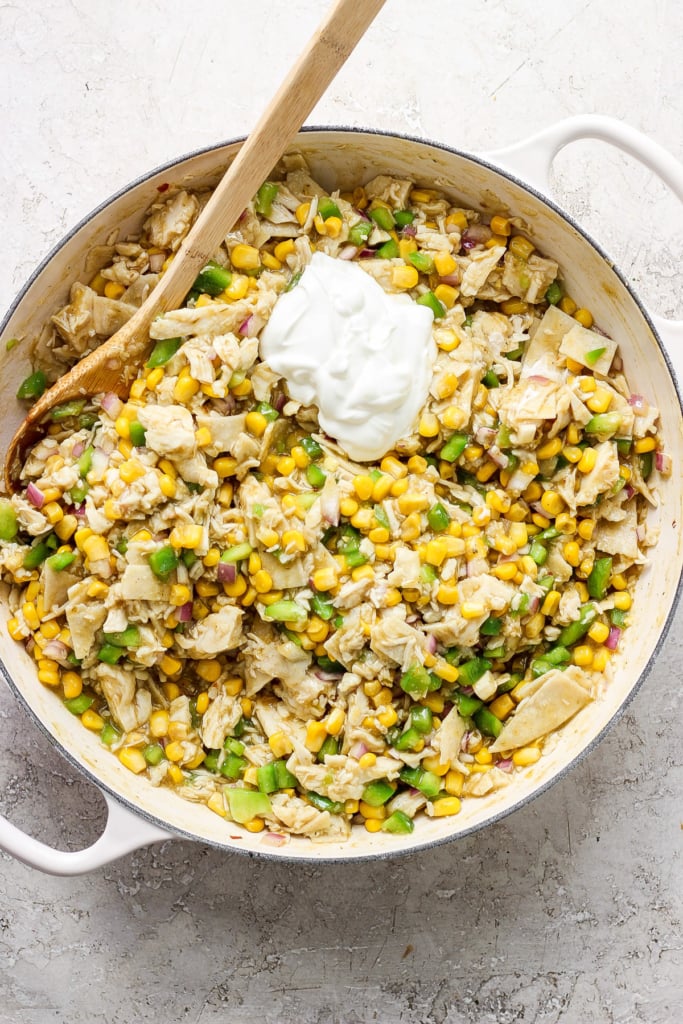 A skillet filled with corn and sour cream.