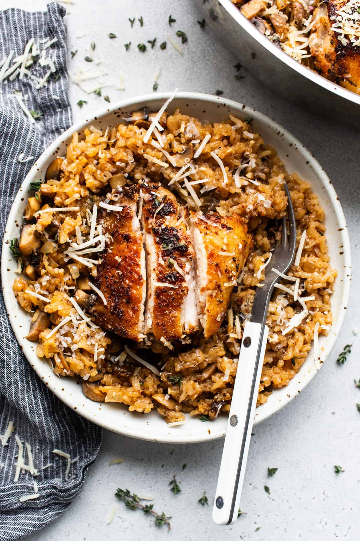 Chicken and rice in a white plate with a fork.