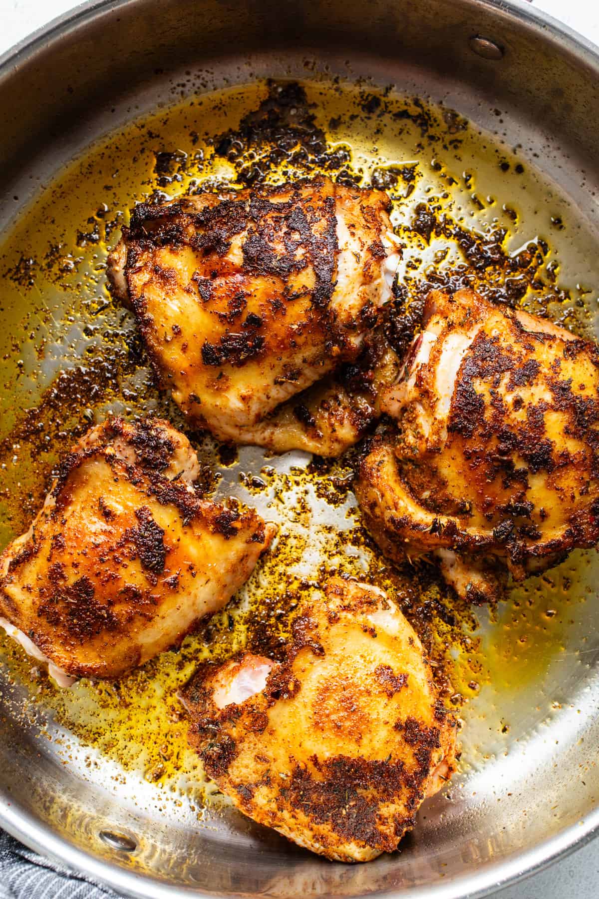 Roasted chicken in a skillet on a white background.