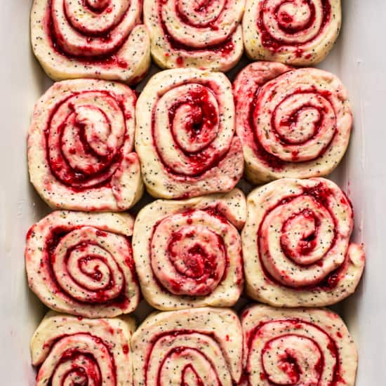 Raspberry roll ups in a white dish.